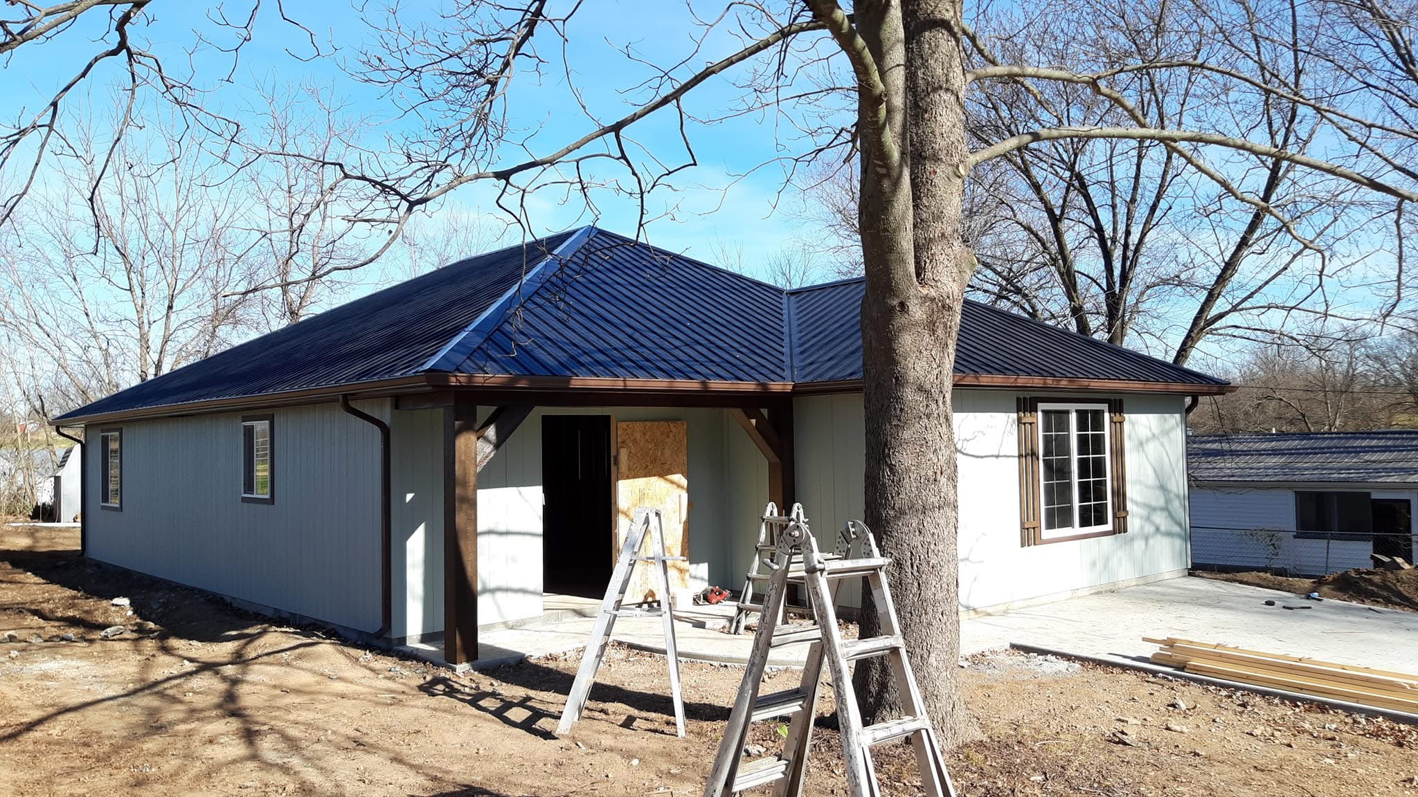 Dark Standing Seam Metal Roof Installation on New Home